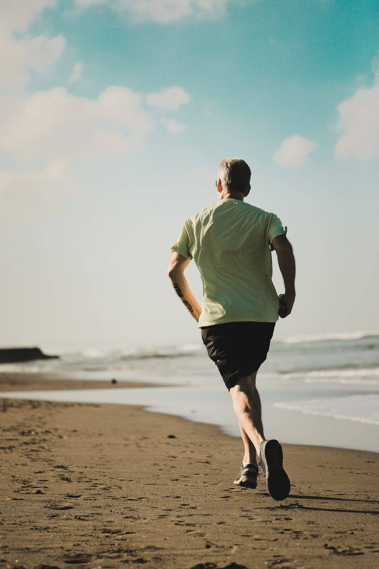 A man running along the beach.