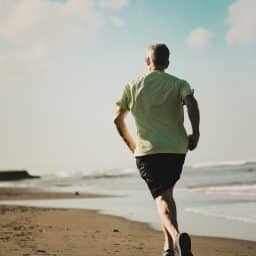 A man running along the beach.