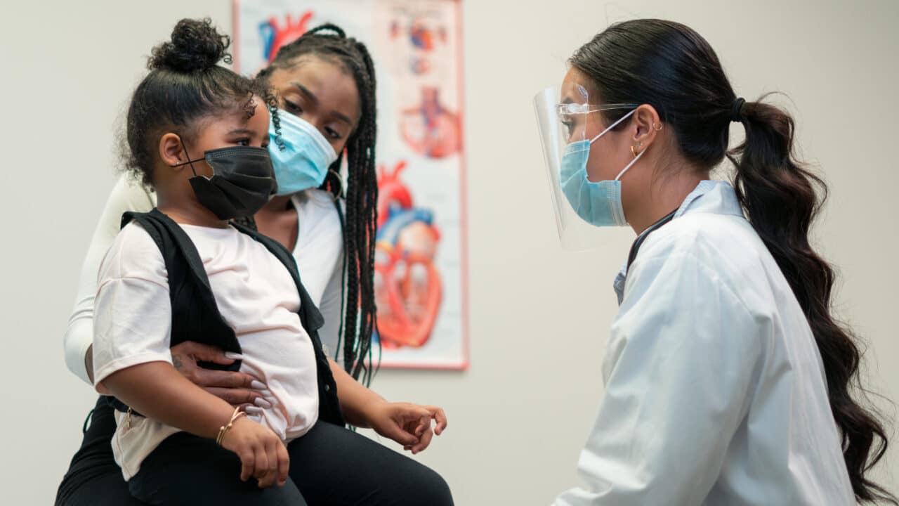 A mother visits the doctor's office with her daughter.