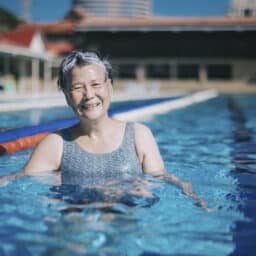 Senior woman smiling in a swimming lane