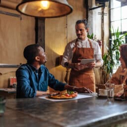 Couple ordering food from a restaurant server