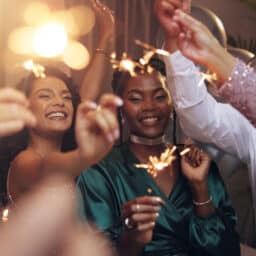 Group of friends holding sparklers on new year's eve