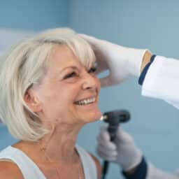 Smiling woman in an ear exam