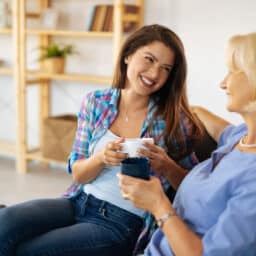 Young woman enjoying the cup of coffee with her mother