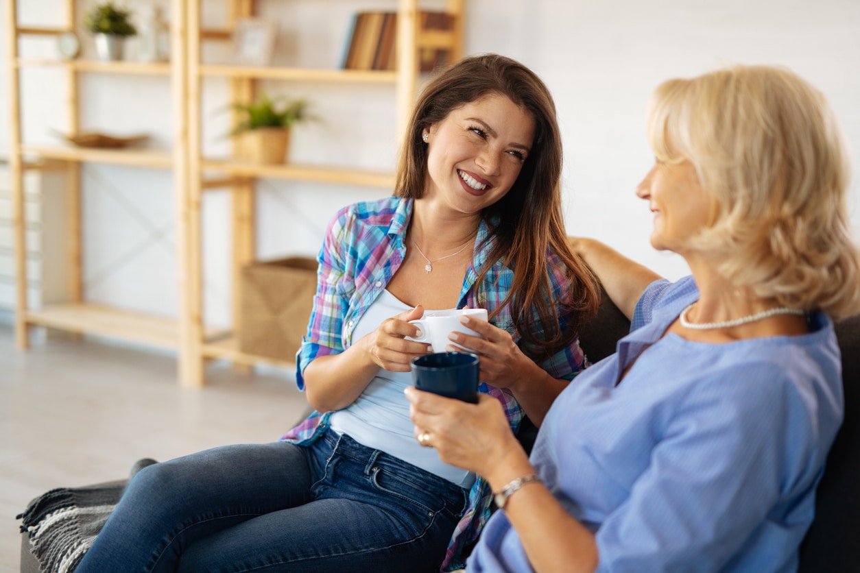 Young woman enjoying the cup of coffee with her mother.