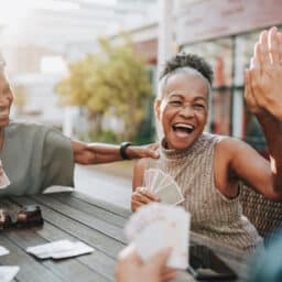 Senior women friends playing card