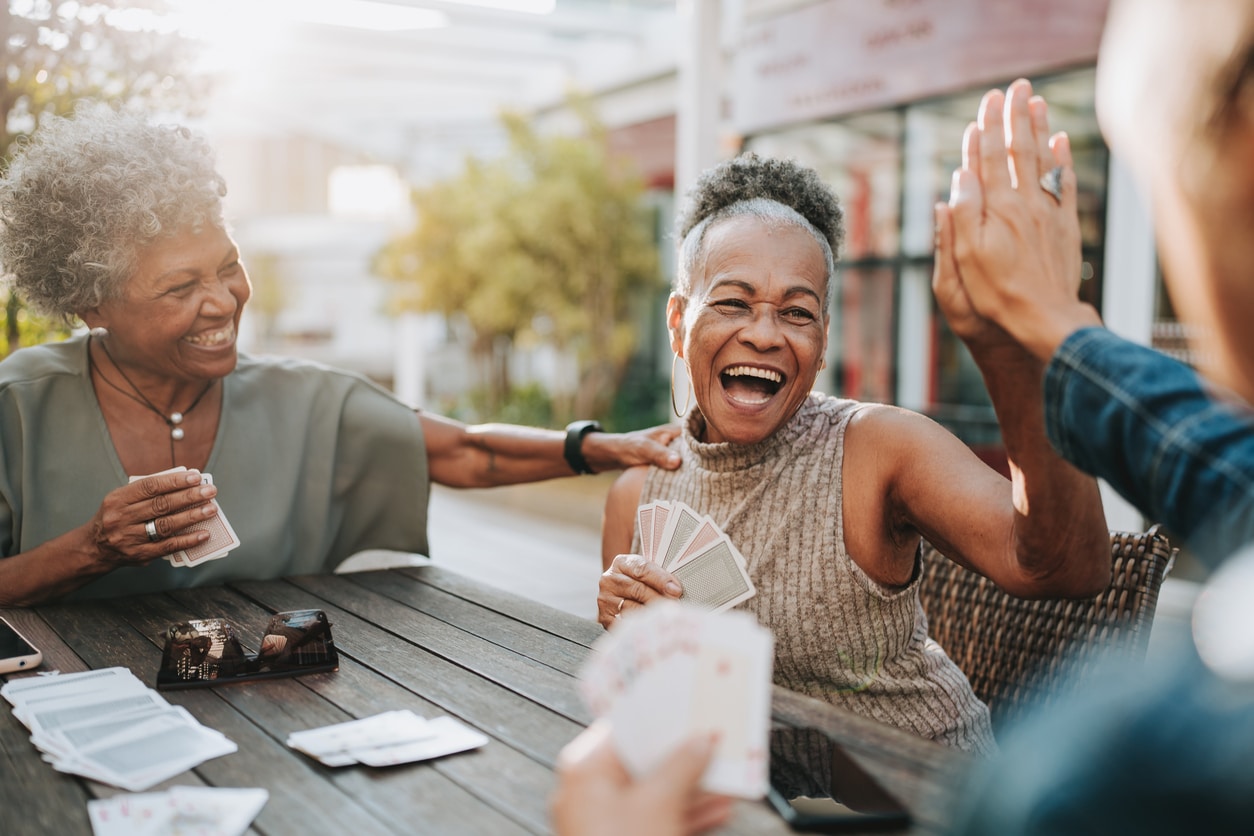 Senior women friends playing card.